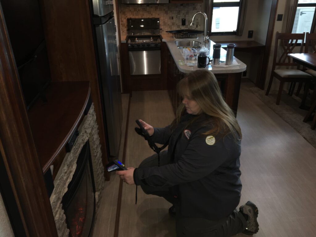 Carol Jackson with RV Inspection Specialists inspects an RV fireplace.