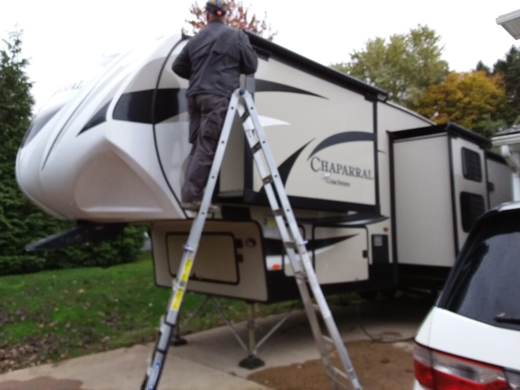 Jim Jackson with RV Inspection Specialists inspects an RV roof.
