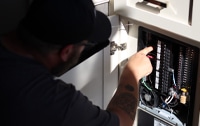 RV Service Pro Working - Jason Carletti checks RV electric panel