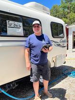 Dana Cooper inspecting and repairing a Casita camper for a customer to sell