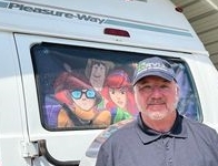 I SPY RV Inspections & More LLC - Dana Cooper beside his Class B Pleasureway campervan.